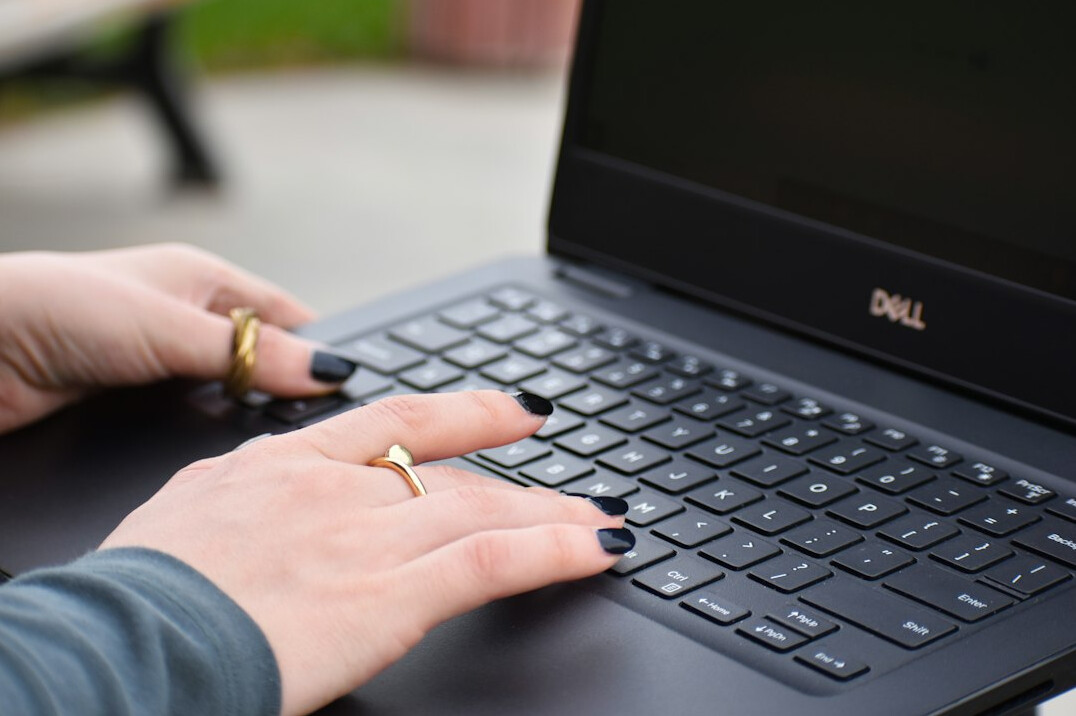 writer typing on laptop